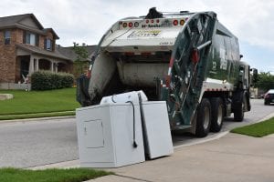 Bulky waste on curbside getting picked up by TDS garbage truck