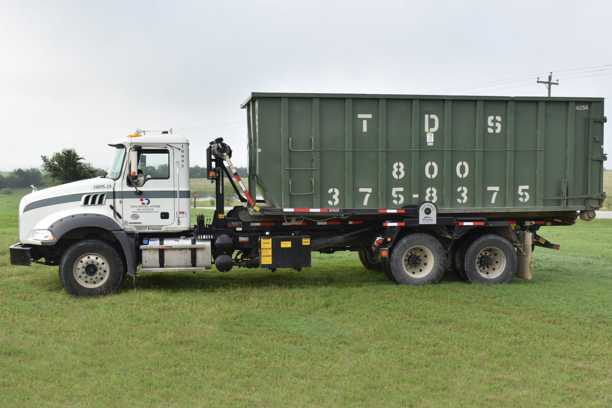 Texas Disposal Systems 40 yard roll-off dumpster on truck