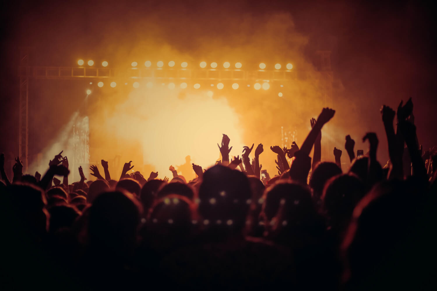 view of concert stage from back of crowd