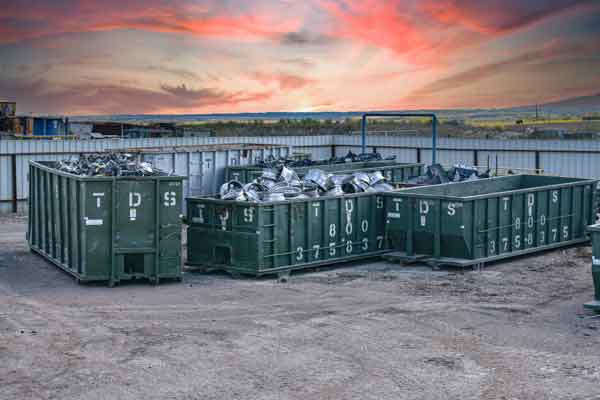 TDS roll-off dumpsters with source separation metals at sunset