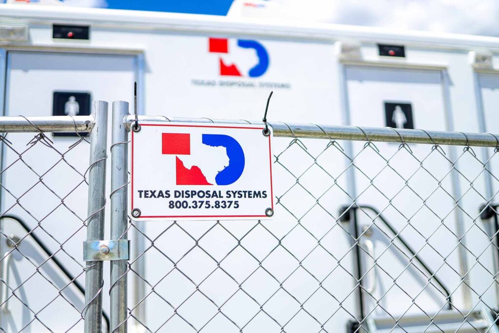 Temporary fencing with the TDS logo panel displayed with zip ties. Has a trailer in the background.