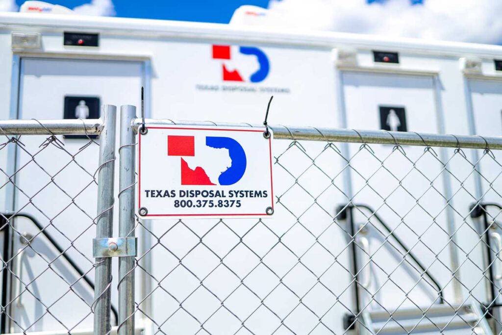 Temporary fencing with the TDS logo panel displayed with zip ties. Has a trailer in the background.