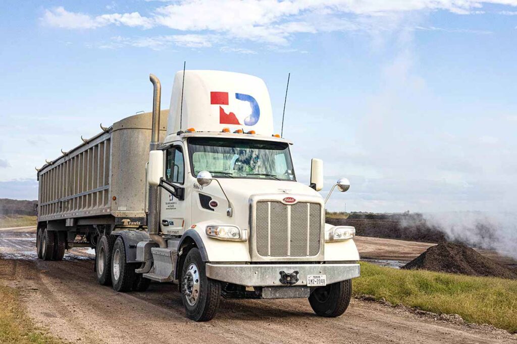 White TDS 18 wheeler truck hauling composting