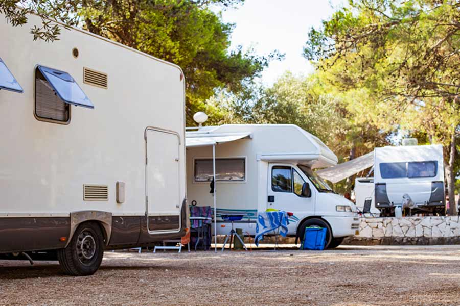 Multiple camper vans parked at a campsite