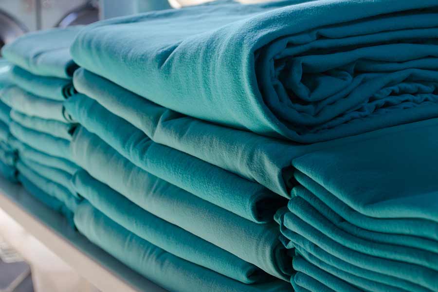 Blue towels folded and arranged in rows