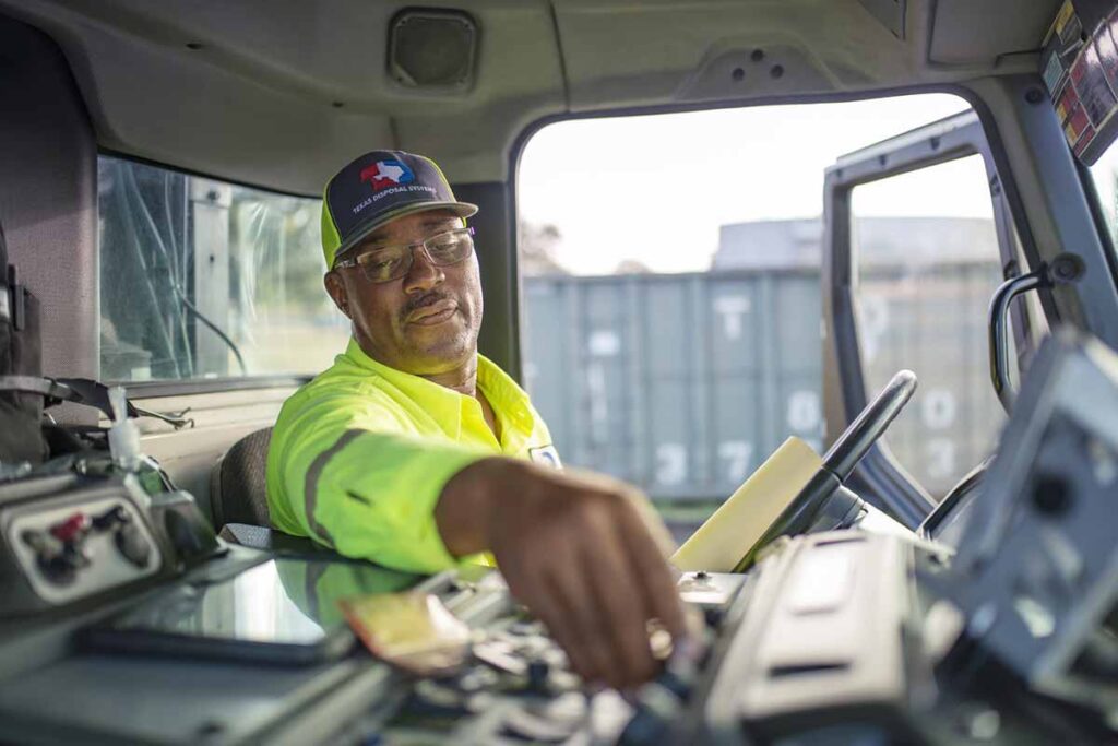 Texas Disposal Systems employee driving a truck
