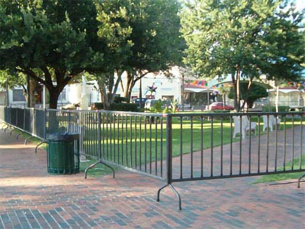 Multiple panels of temporary fencing arranged in a public space
