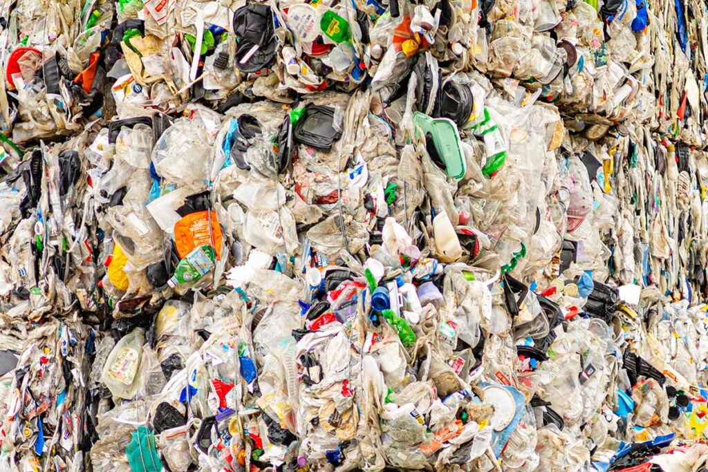 Bundle of multicolor recycled plastic bottles including laundry detergent bottles and water bottles