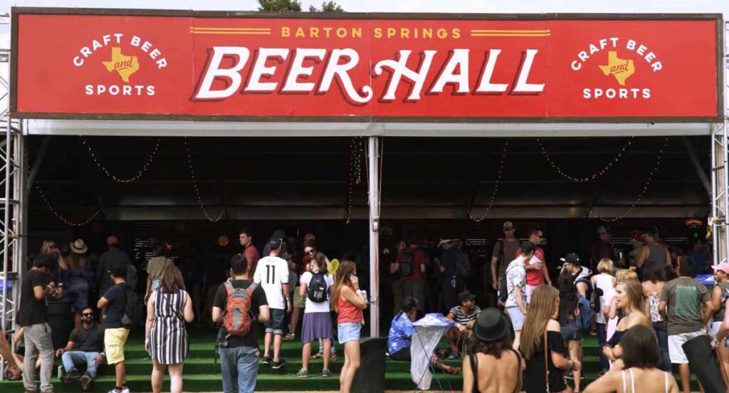 Beer hall tent with red sign and event goers