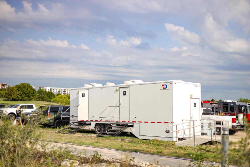 TDS luxury restroom trailer parked in parking lot for an event