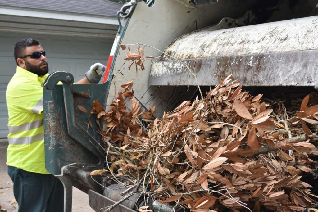 TDS employee putting brush into TDS truck