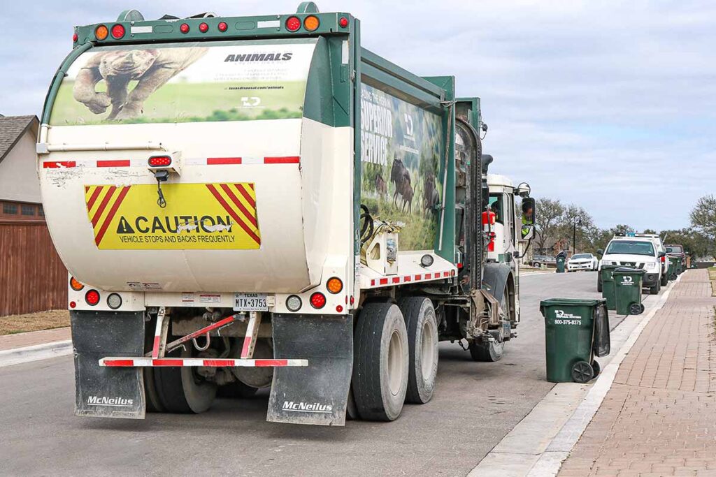 The back of green TDS truck on neighborhood road