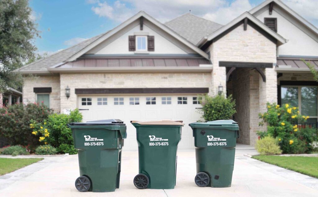 Green TDS trash compost recycling carts in front of house