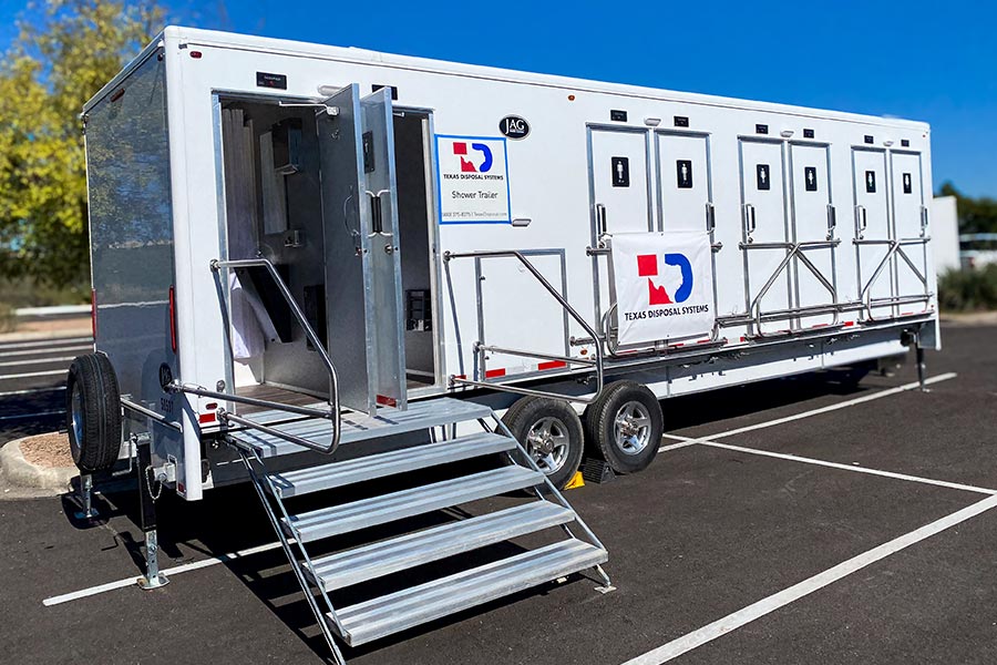 TDS white shower trailer with stairs parked in a lot