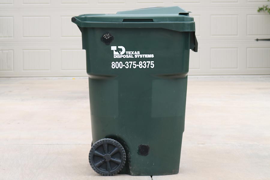TDS green composting cart with green lid in front of garage door