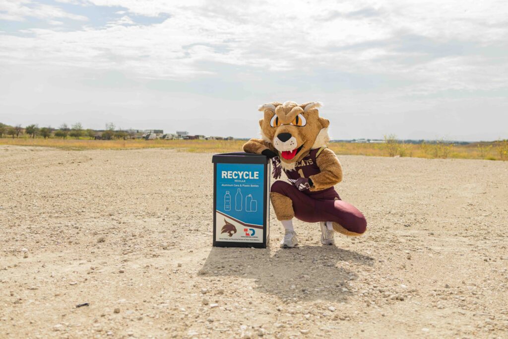 Boko the Bobcat posing with an eco station