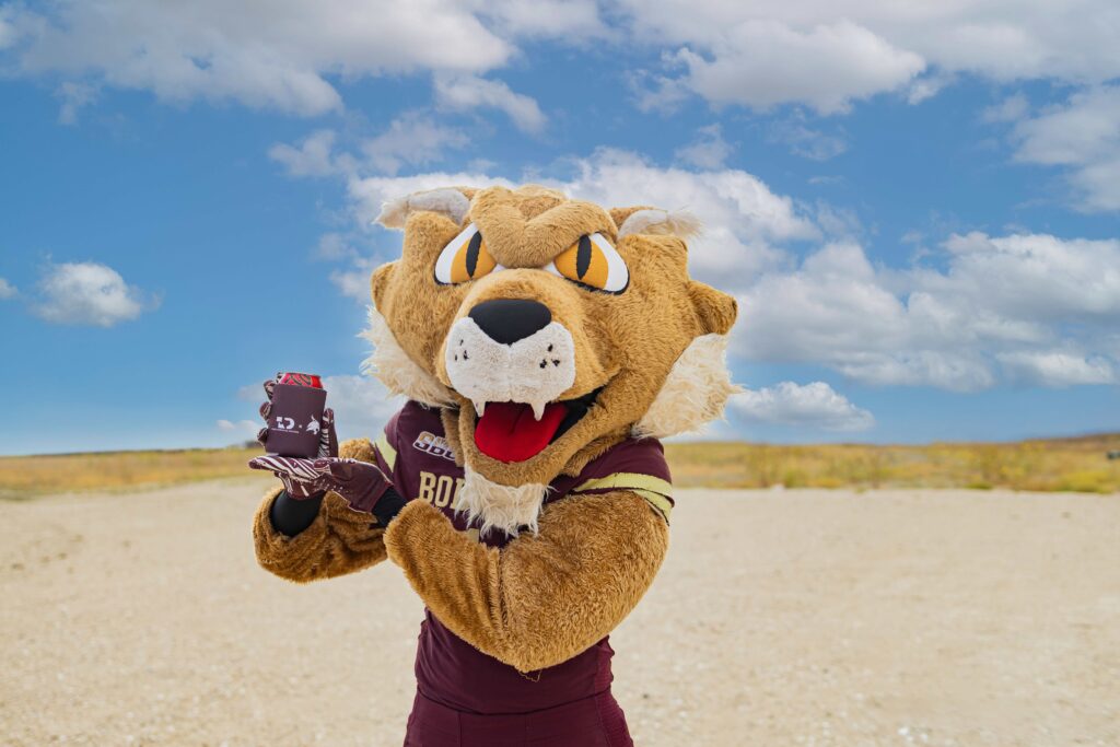 Boko holding a Texas Disposal Systems coozie
