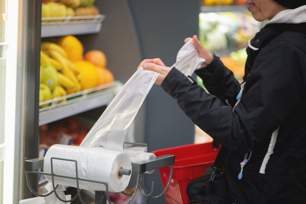 Woman using a grocery bag at the grocery store